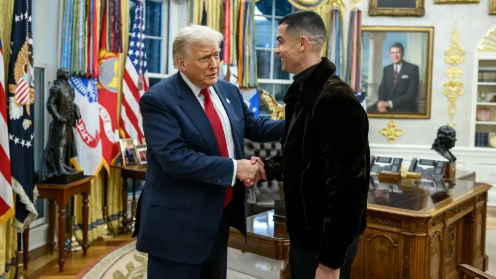 U S President donald trump shakes hands with cristiano ronaldo in a black jacket inside an ornate office setting