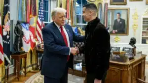 U S President donald trump shakes hands with cristiano ronaldo in a black jacket inside an ornate office setting
