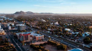 A panoramic aerial photo of gaborone botswana showing city buildings roads and residential areas with distant hills under a clear sky