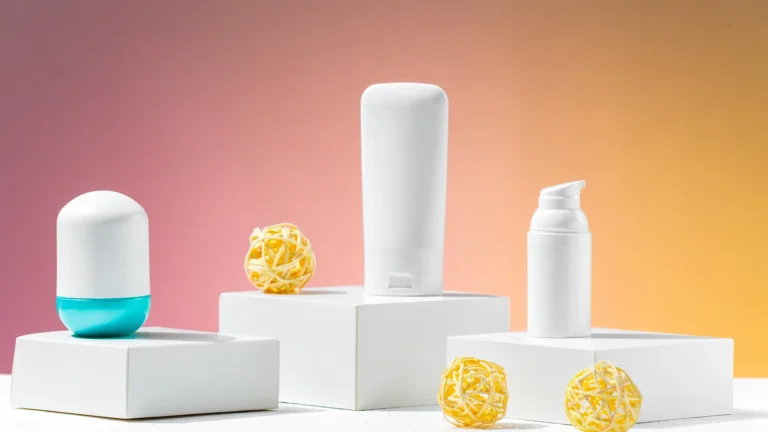 Cosmetic skincare bottles displayed on stylish white stands against a gradient background.