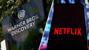 A split image showing the warner bros Discovery logo on an outdoor sign and the netflix logo displayed on a smartphone screen