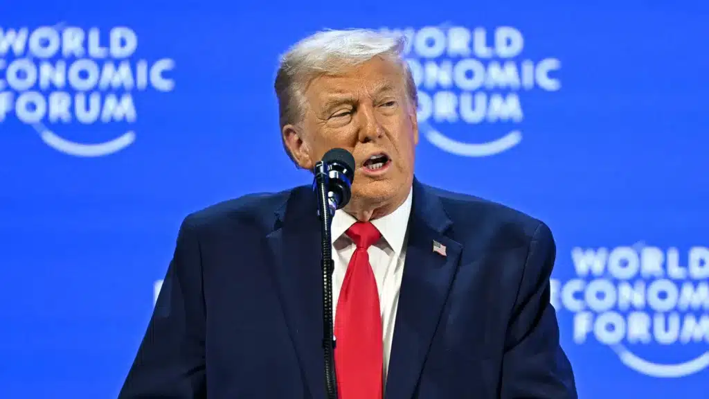 Donald Trump Addresses the World Economic Forum at Davos 2026 | Brimco Donald trump stands at the world economic forum podium delivering a speech at the annual meeting davos 2026 with wef branding visible on a blue background