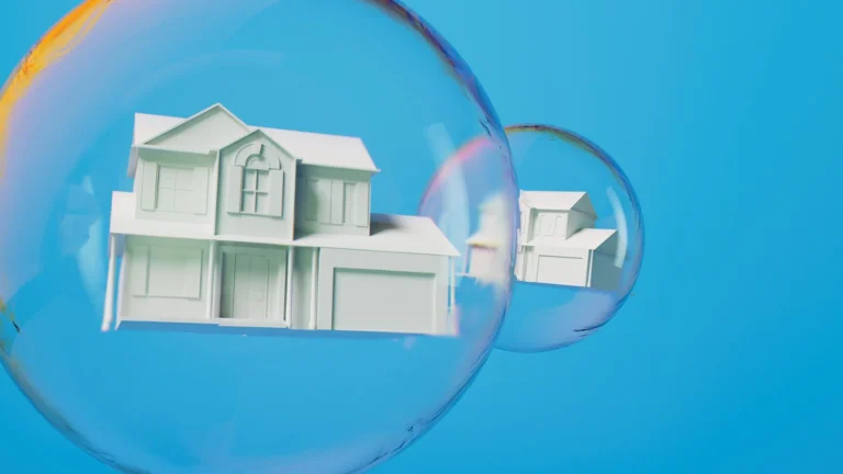 Two white model houses inside transparent soap bubbles on a blue background, representing a housing market bubble.