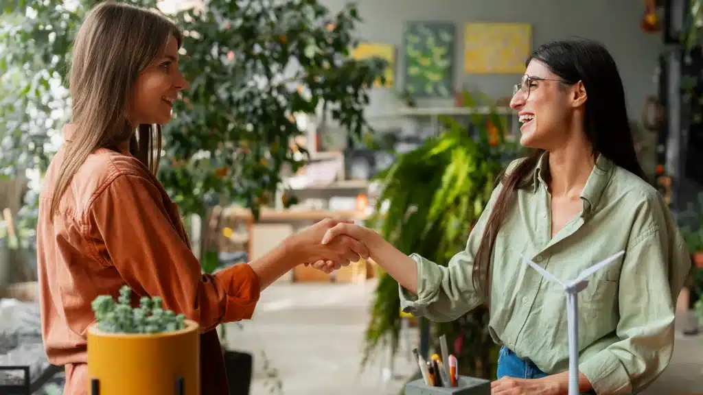 Building Authentic Customer Relationships Through Personal Engagement | Brimco Two business professionals shaking hands during a meeting representing authentic customer relationships and trust building