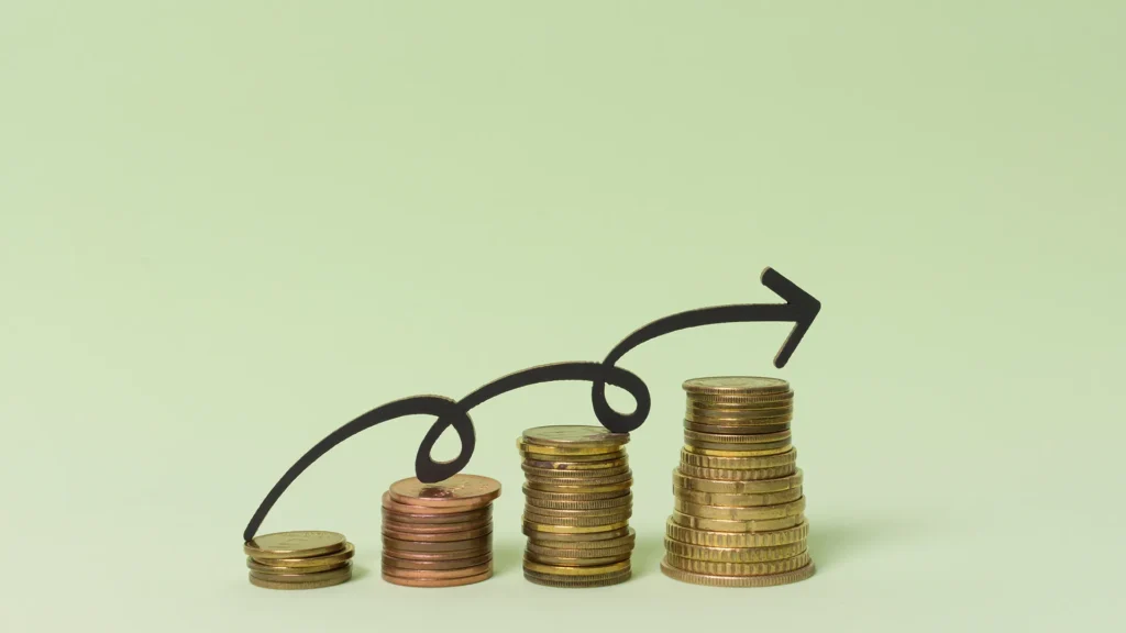 Cash Flow Growth and Revenue Increase Strategy | Brimco Stacked coins increasing in height with upward arrow symbolizing cash flow growth and revenue improvement