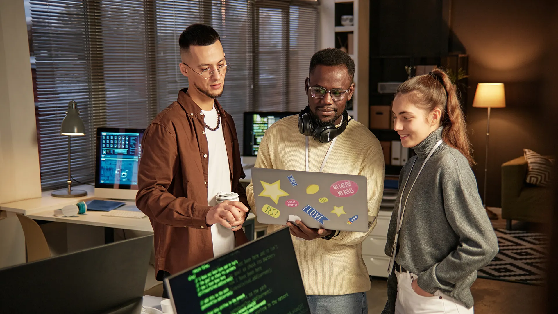 Best Open Source Software for Developers | Brimco Software developers collaborating on open source project using laptop in modern office workspace