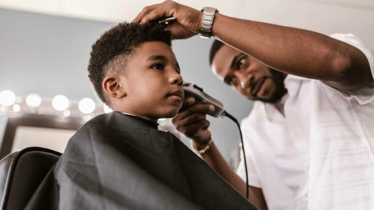 Man cutting boy hair