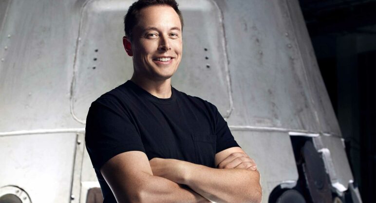 Elon Musk (man) smiling at camera