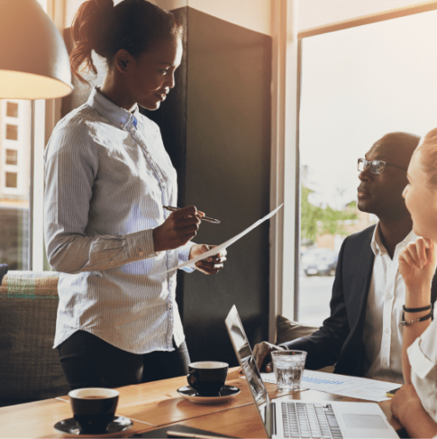 Woman standing in board meeting